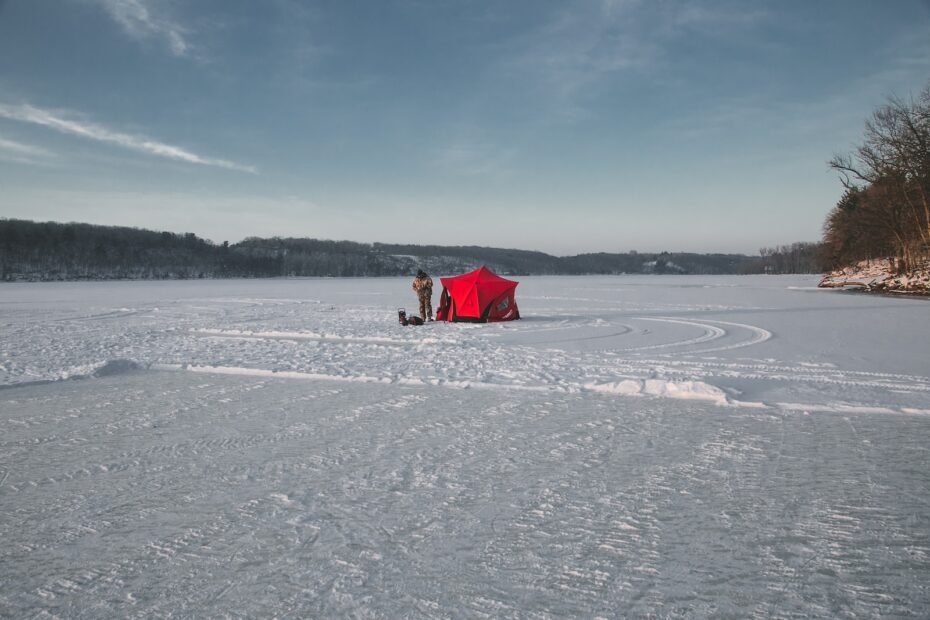 person in red and white dress walking on snow covered field during daytime